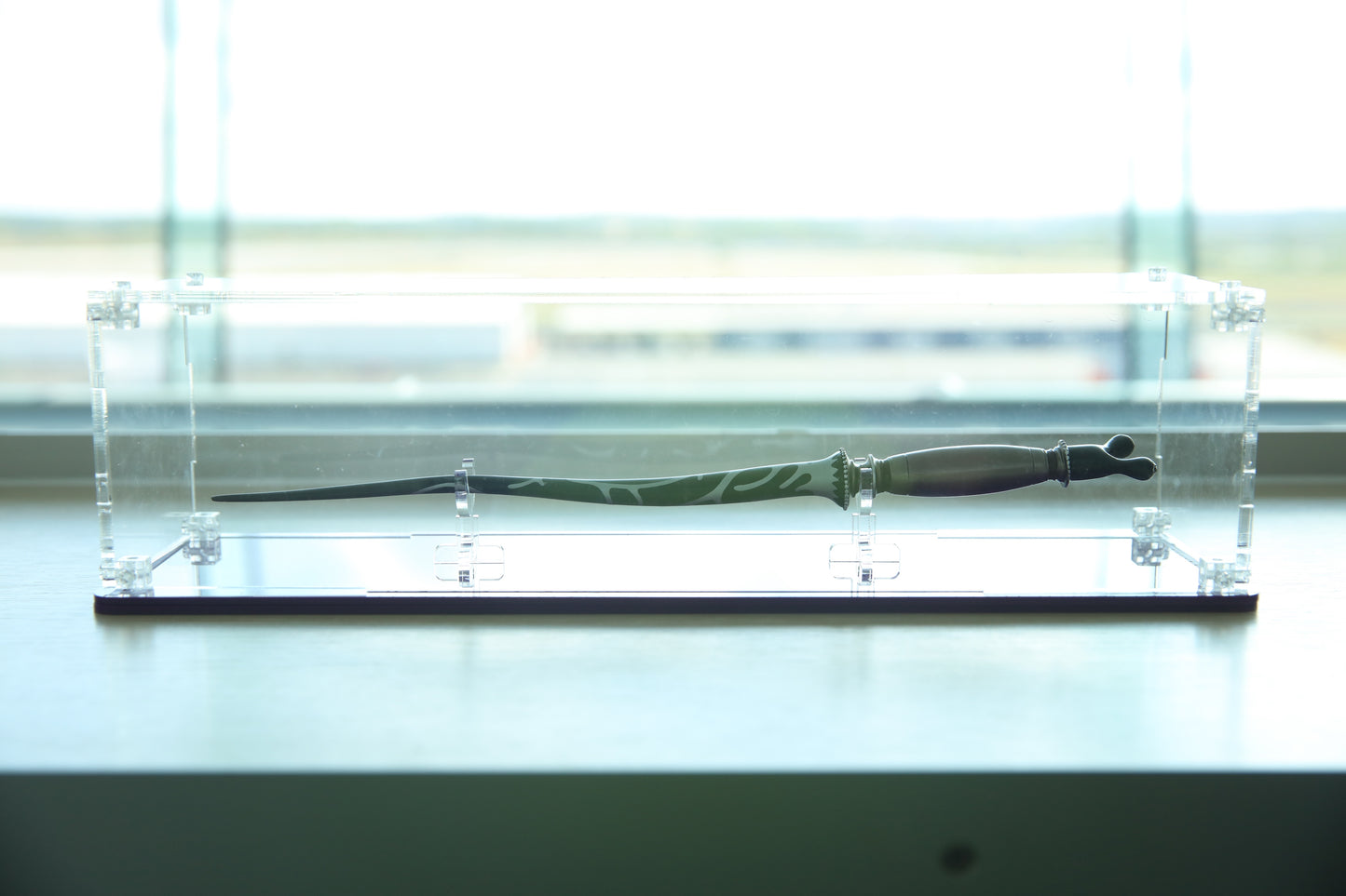 Clear acrylic wand display case with coloured base.