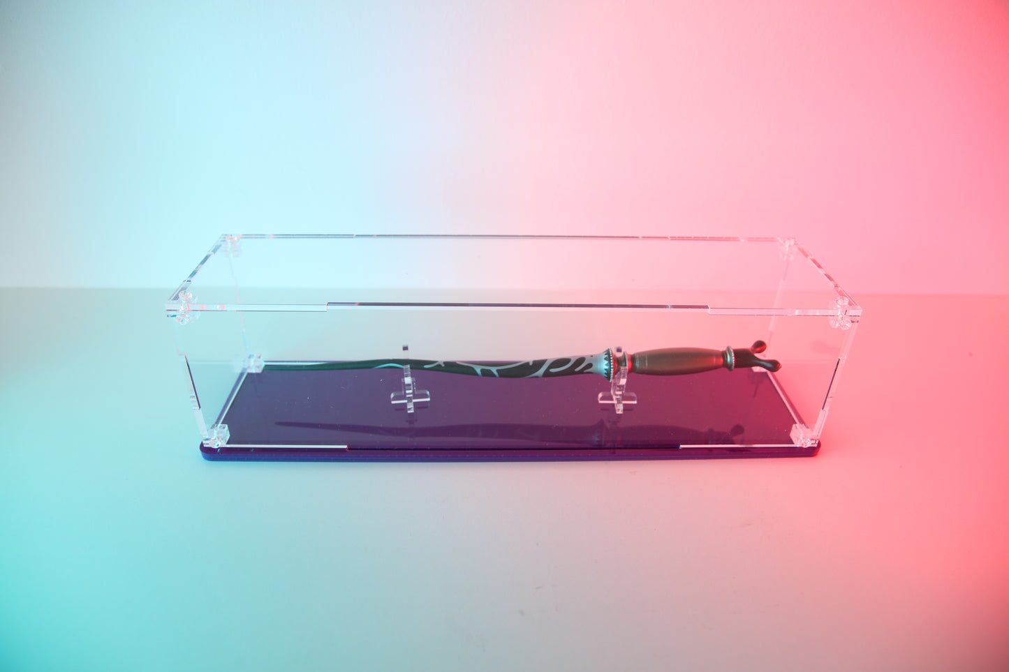 Clear acrylic wand display case with coloured base.