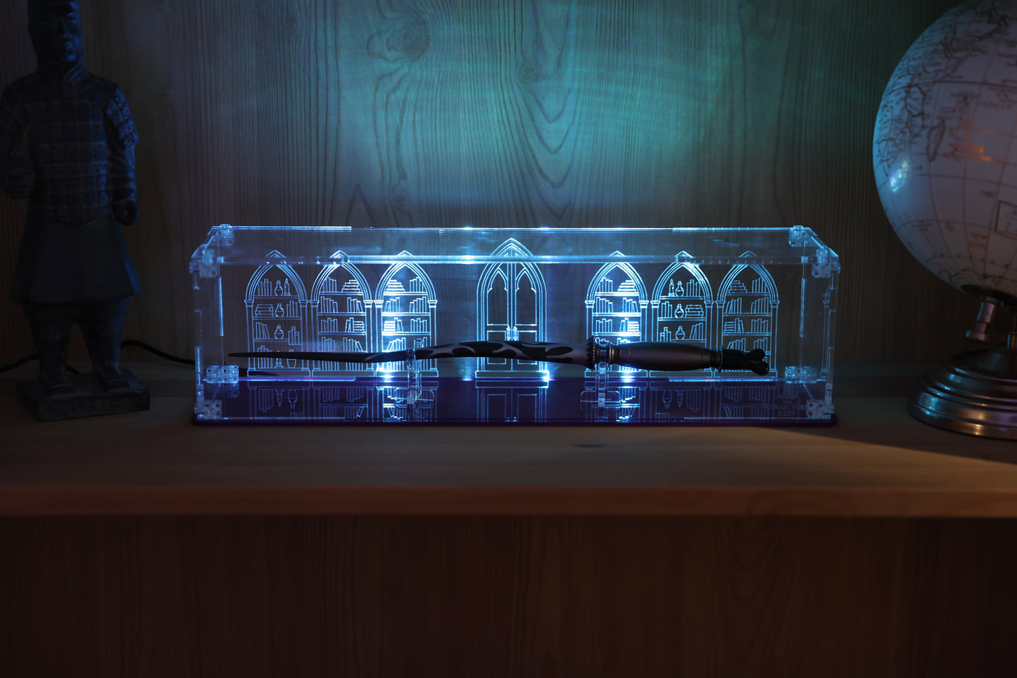 Clear acrylic wand display case with coloured base and library engraving on the back.