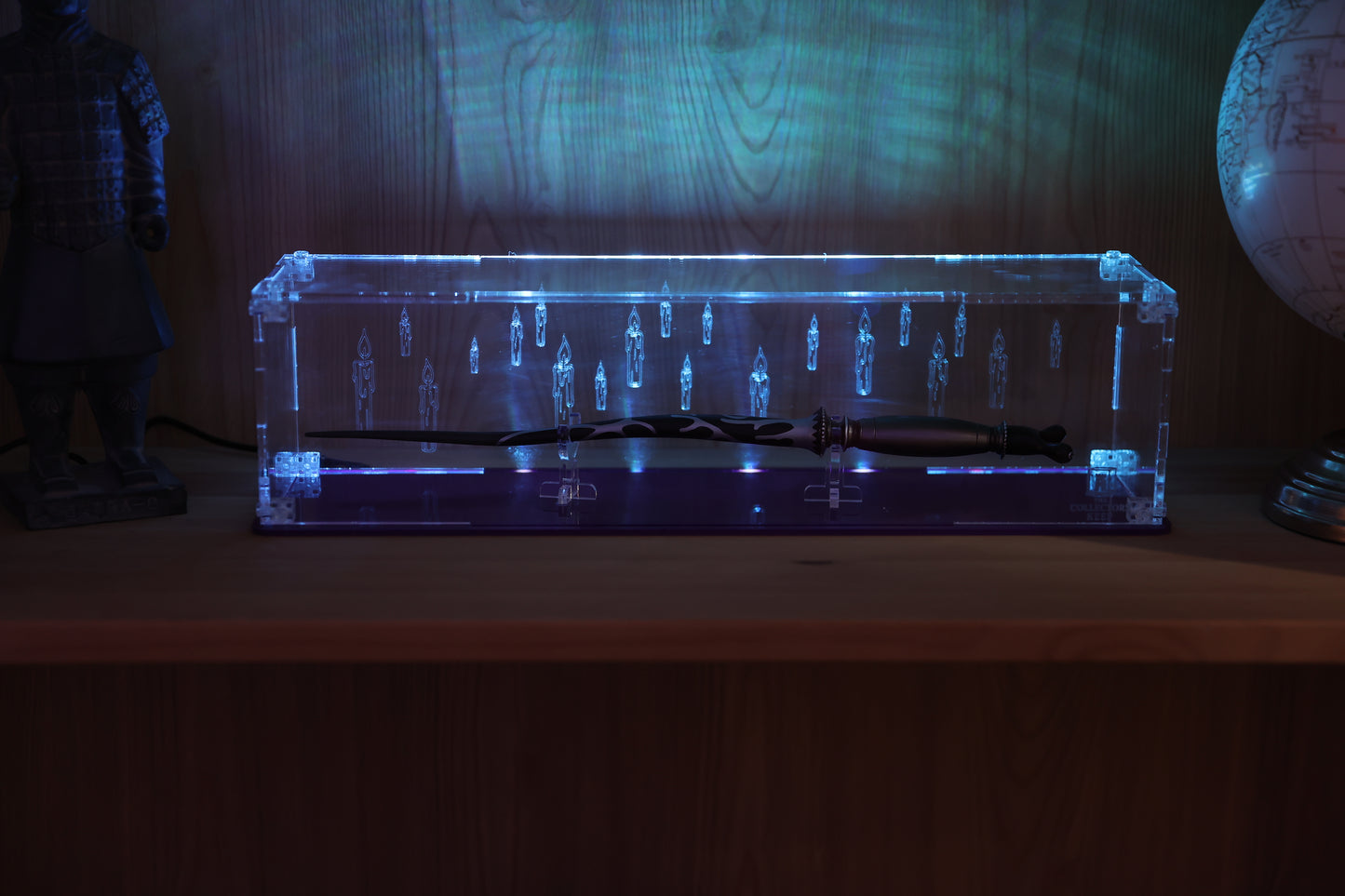 Clear acrylic wand display case with coloured base and candle engraving on the back.
