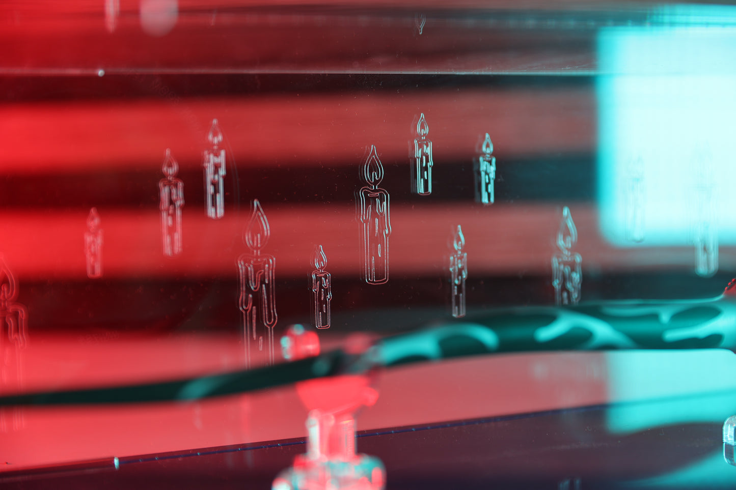 Close up of candle engraving on clear acrylic wand display case.