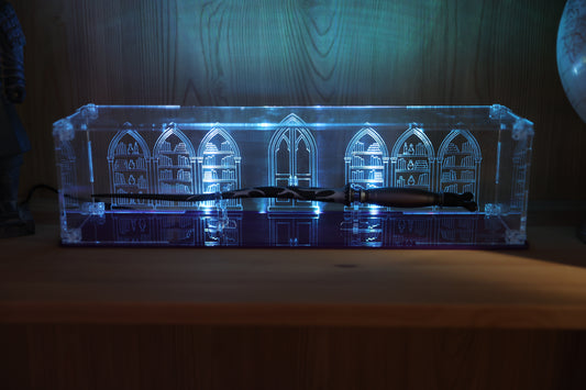 Clear acrylic wand display case with coloured base and library engraving on the back.