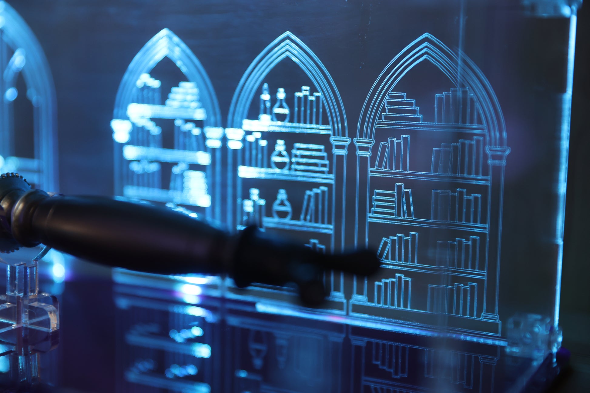 Close up of library engraving on clear acrylic wand display case.