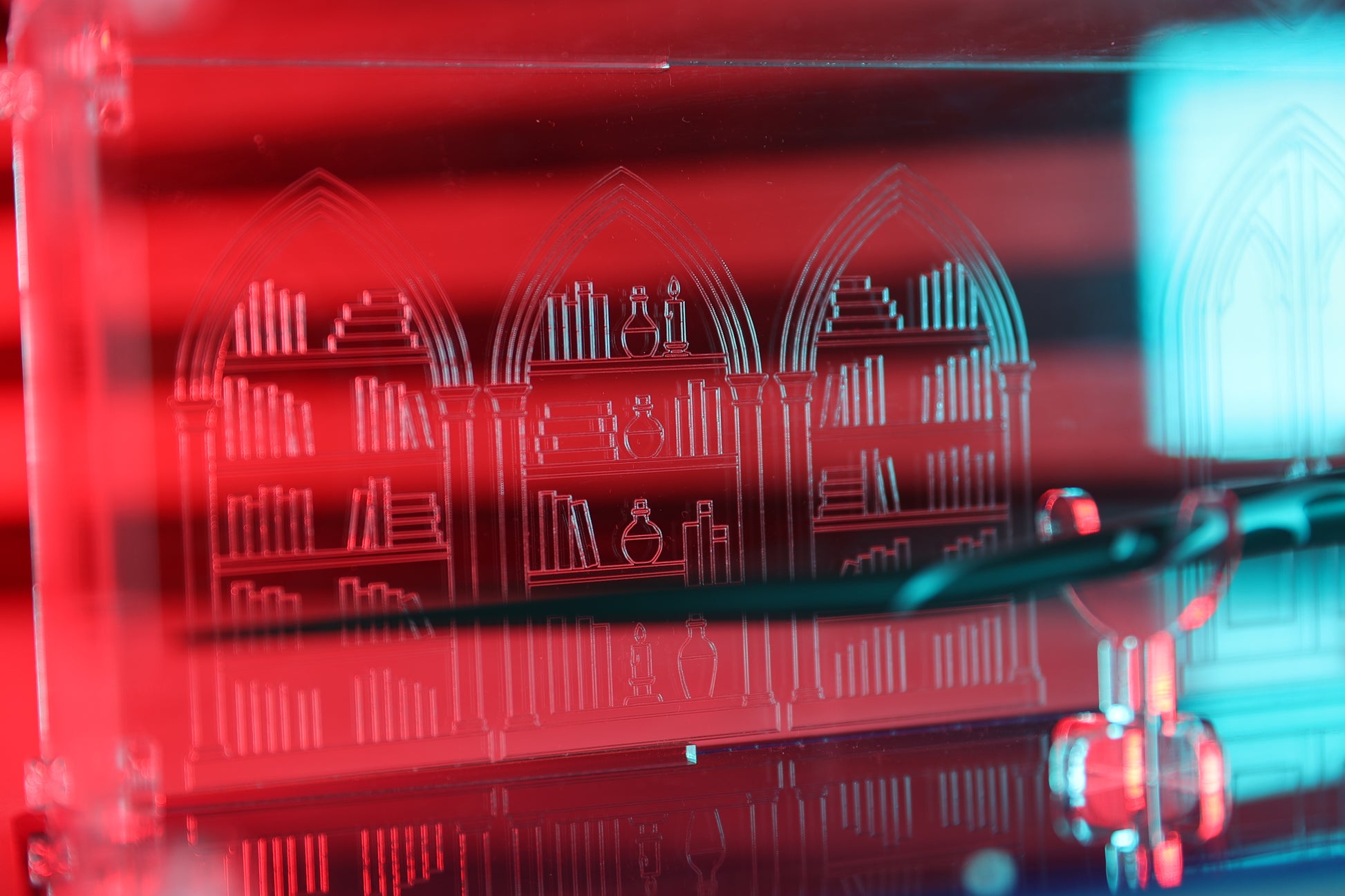 Close up of library engraving on clear acrylic wand display case.