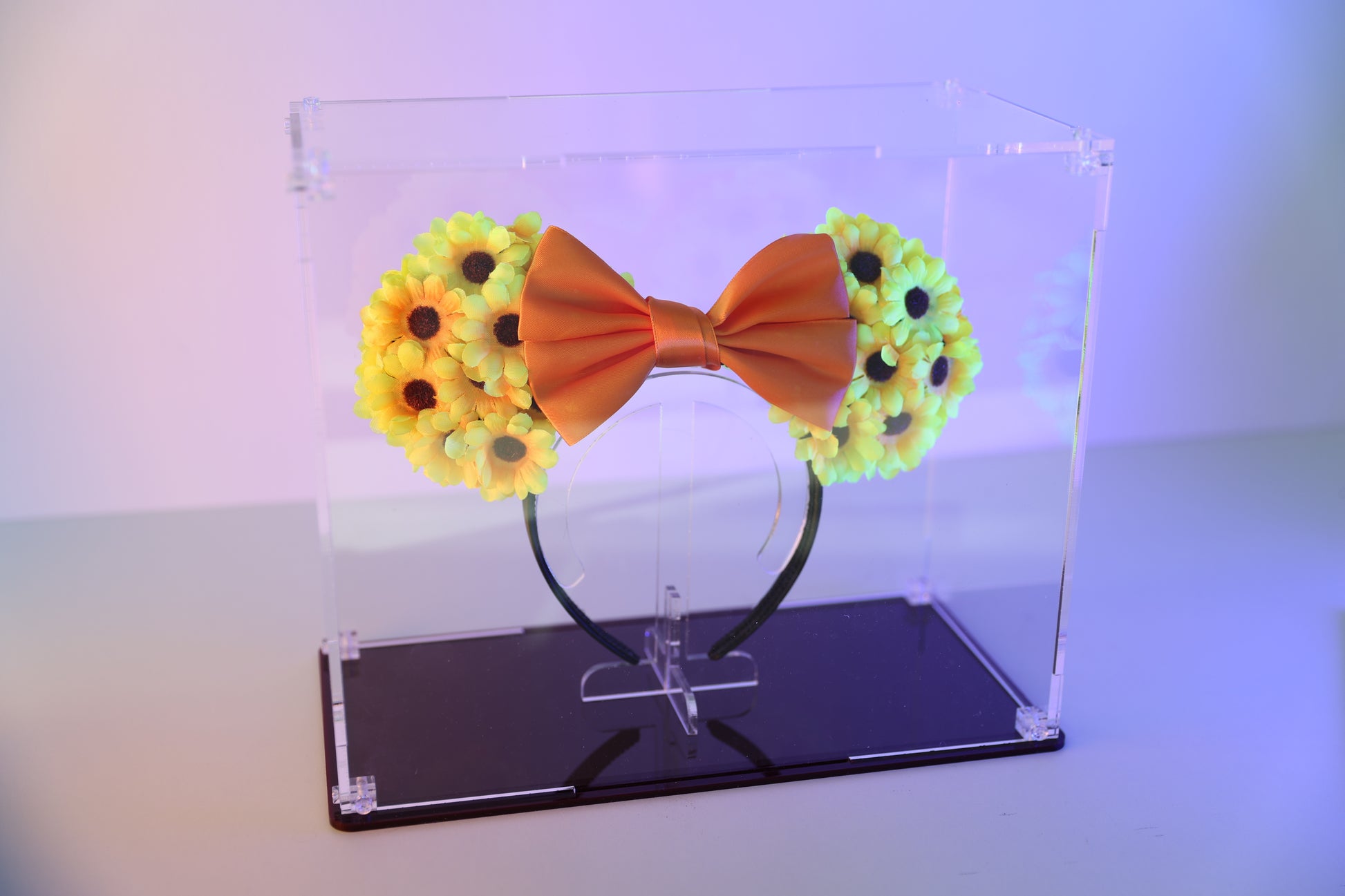 Mickey ears headband in a clear display case with coloured base.