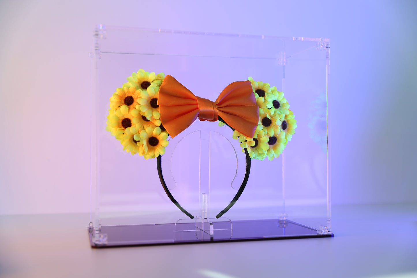 Mickey ears headband in a clear display case with coloured base.