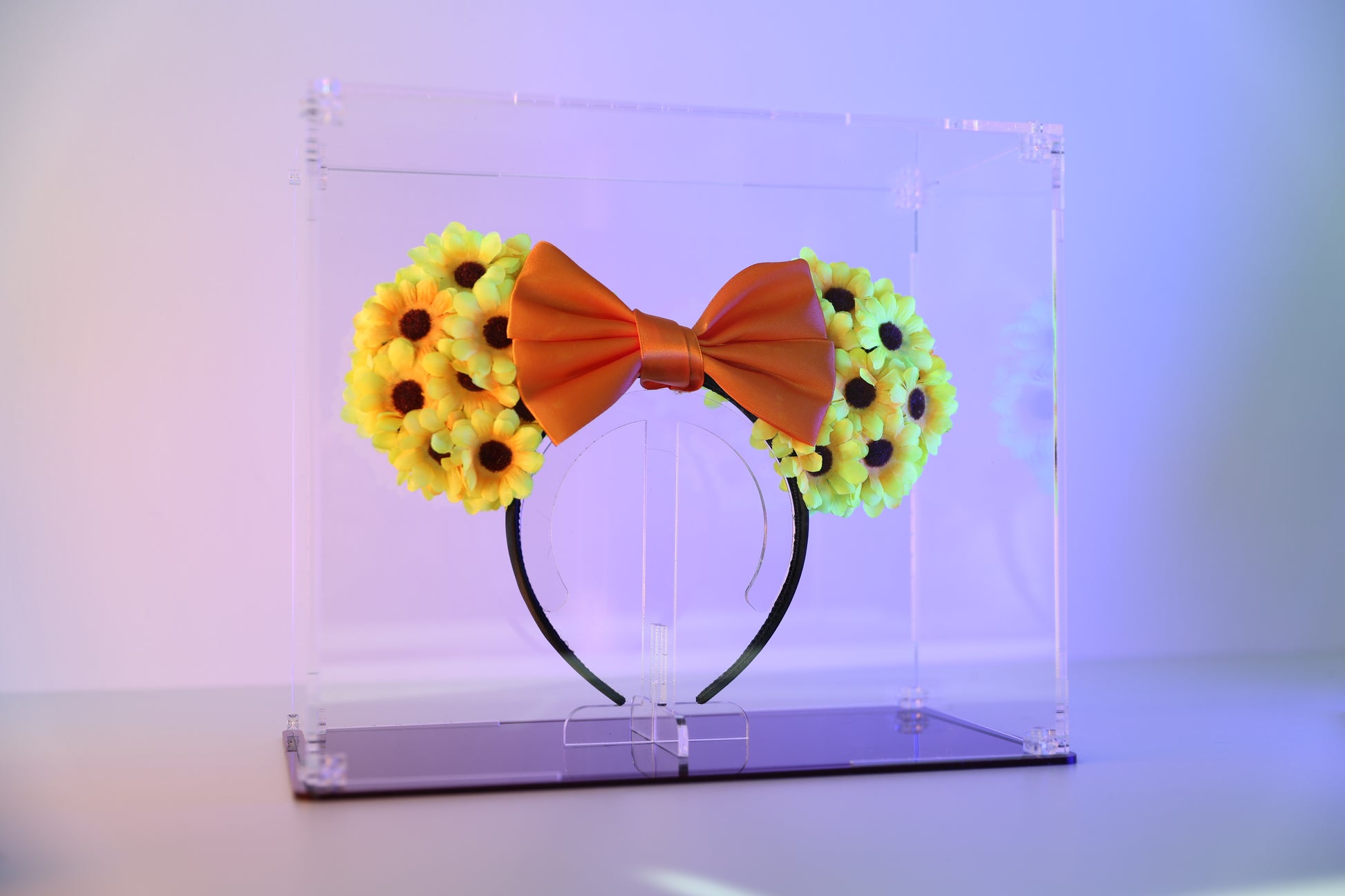 Mickey ears headband in a clear display case with coloured base.