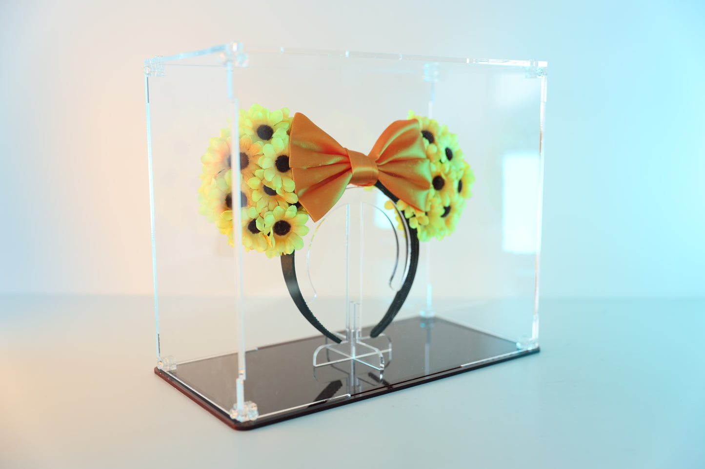 Mickey ears headband in a clear display case with coloured base.