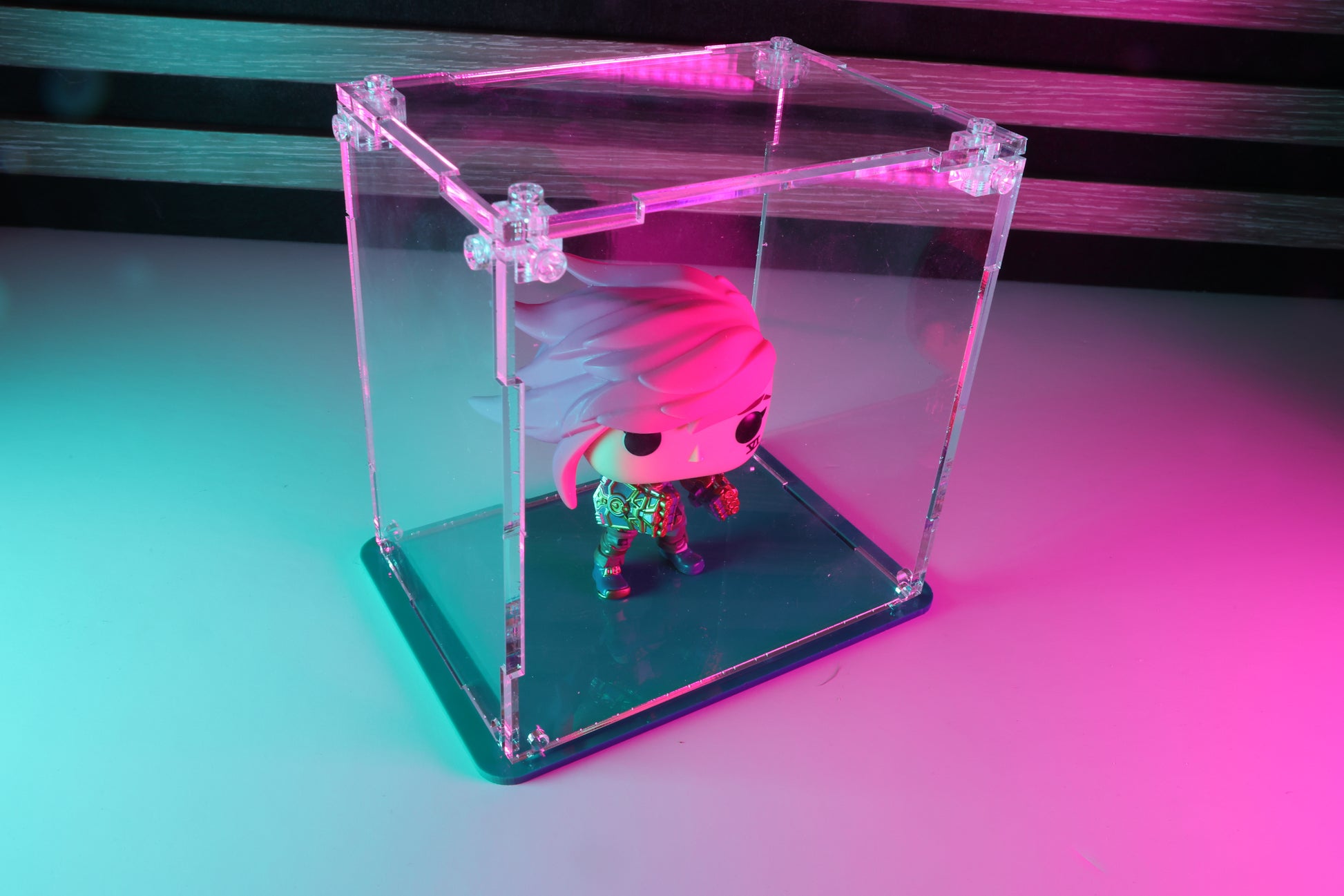 Funko Pop! vinyl figure in a clear acrylic display case with a coloured base.