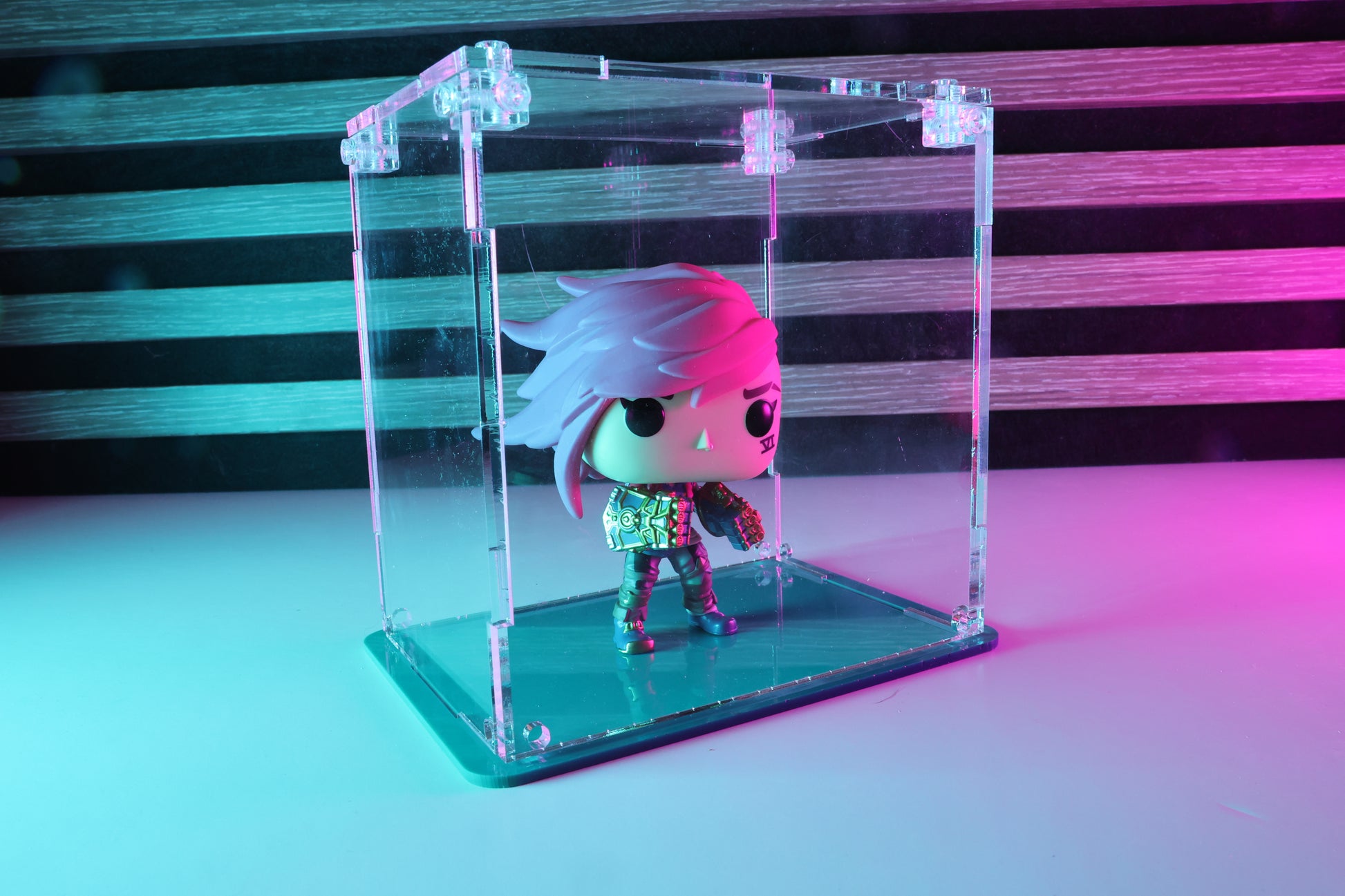 Funko Pop! vinyl figure in a clear acrylic display case with a coloured base.