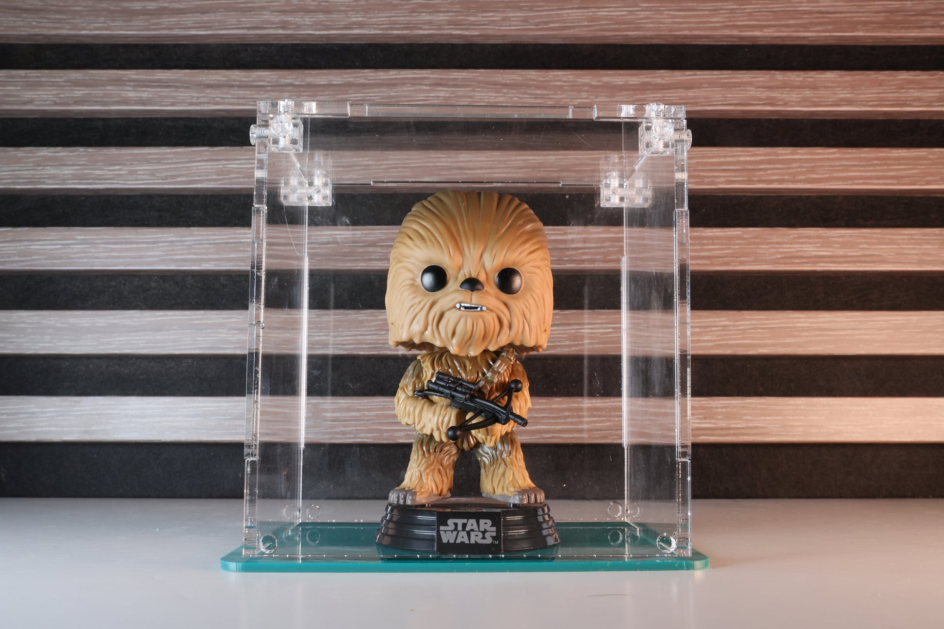 Funko Pop! vinyl figure in a clear acrylic display case with a coloured base.
