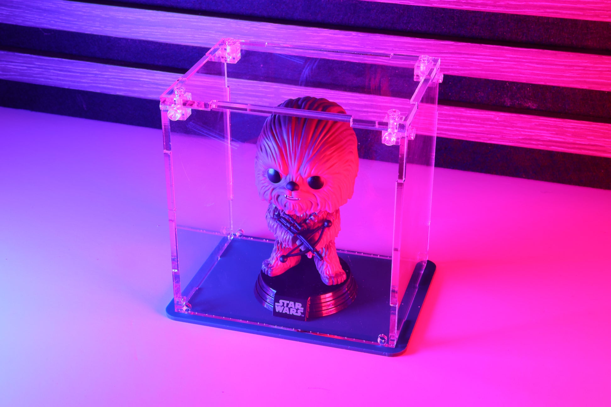 Funko Pop! vinyl figure in a clear acrylic display case with a coloured base.