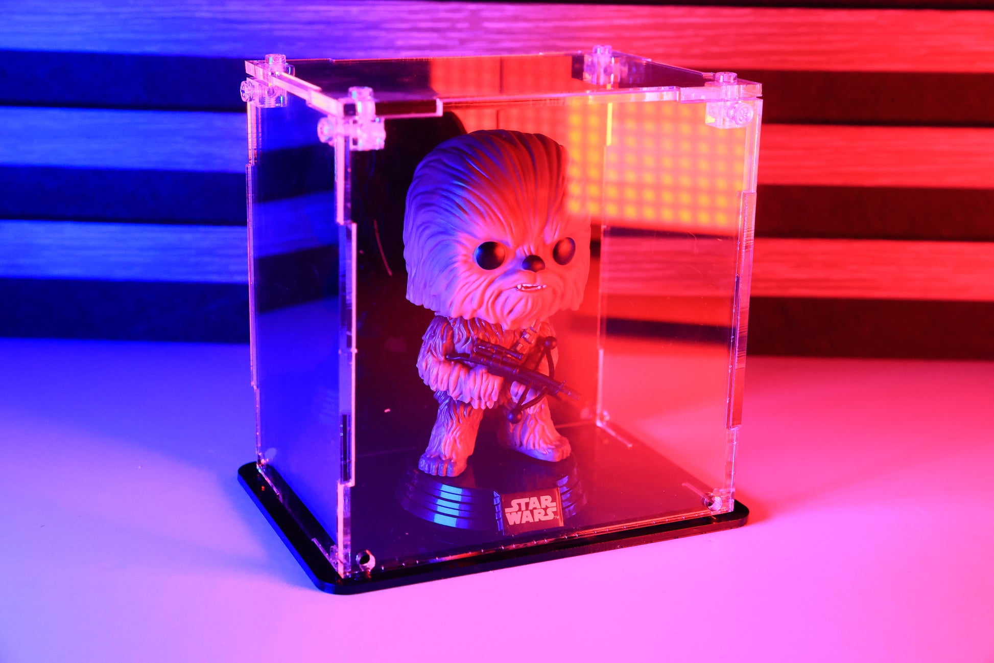 Funko Pop! vinyl figure in a clear acrylic display case with a coloured back.