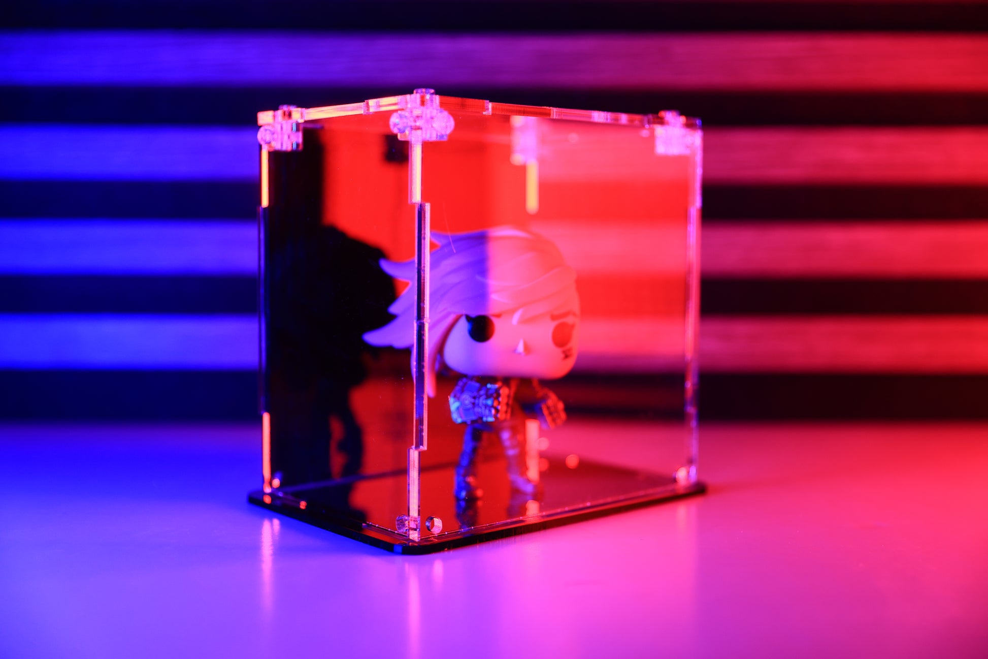 Funko Pop! vinyl figure in a clear acrylic display case with a coloured back.