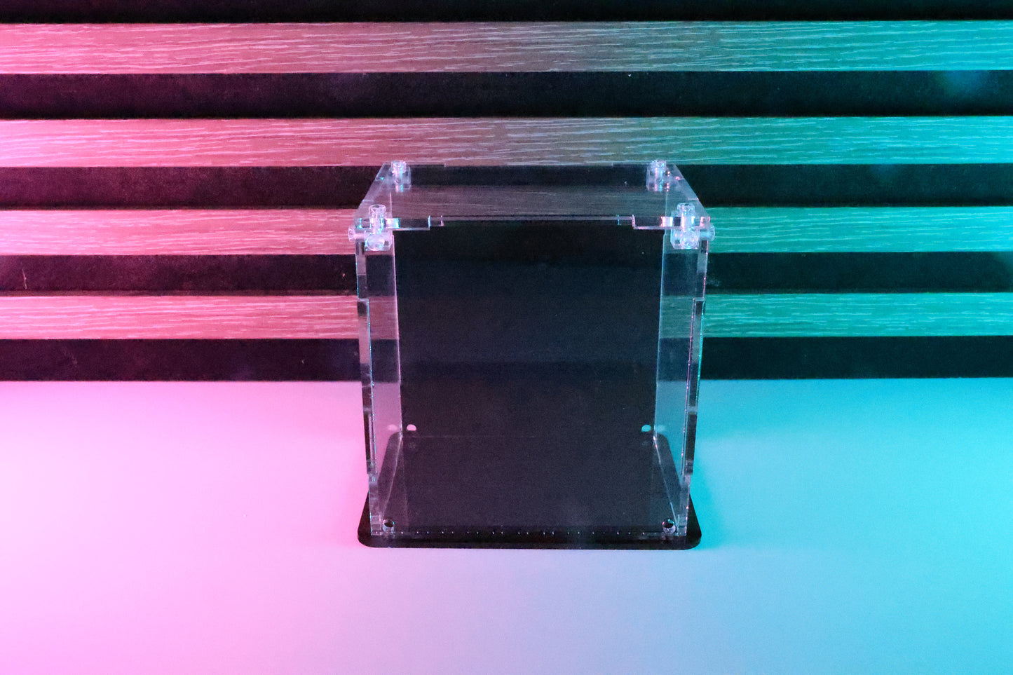 Funko Pop! clear acrylic display case with a coloured back and base.