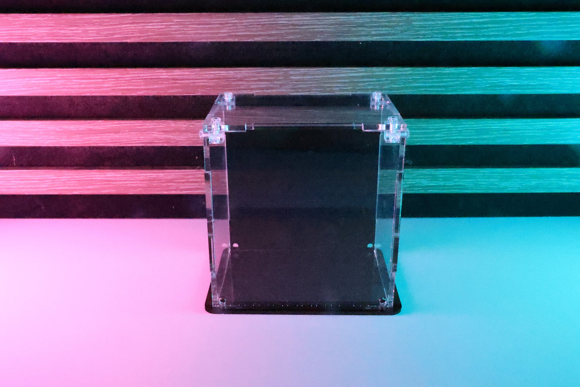 Funko Pop! clear acrylic display case with a coloured back and base.