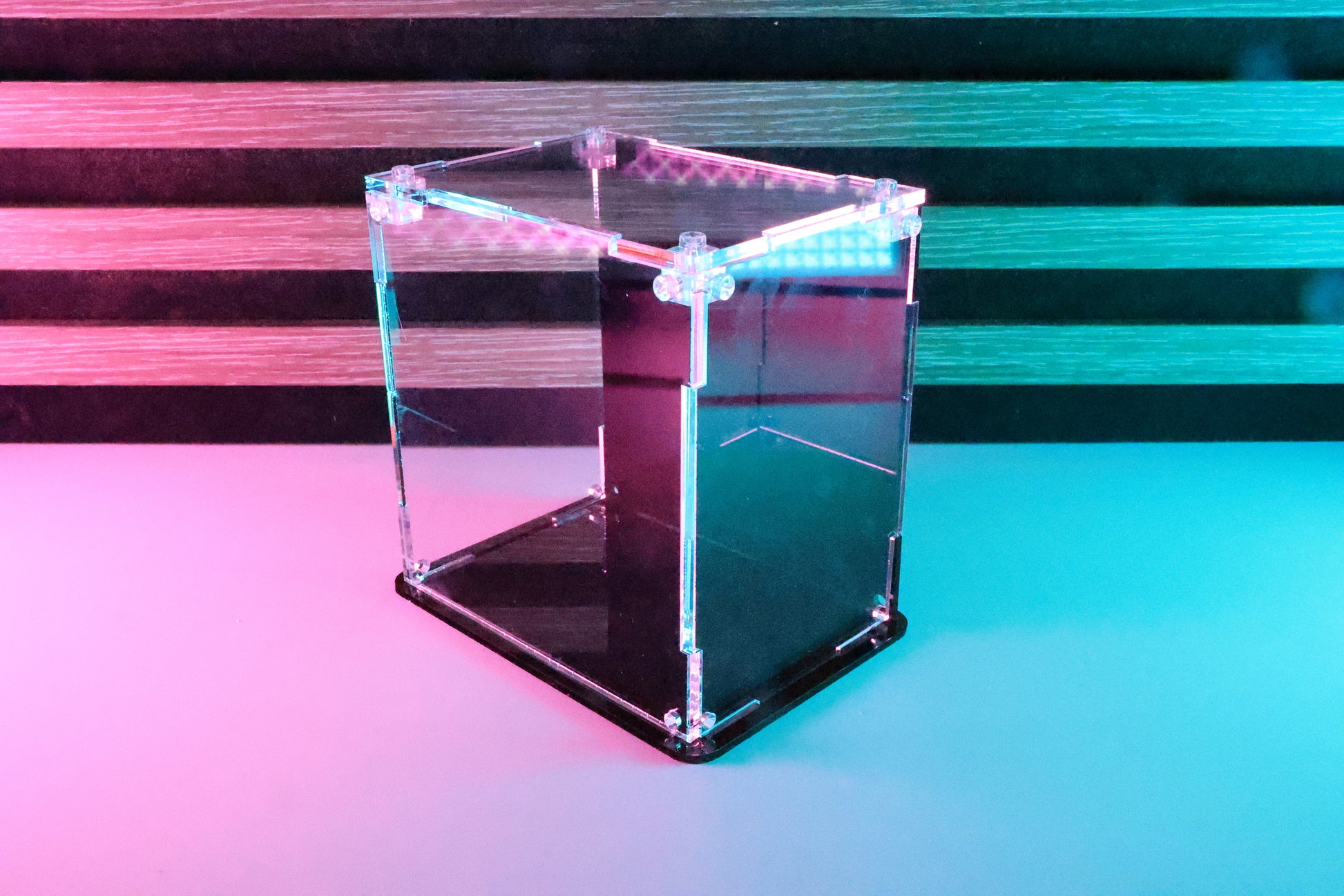 Funko Pop! clear acrylic display case with a coloured back and base.