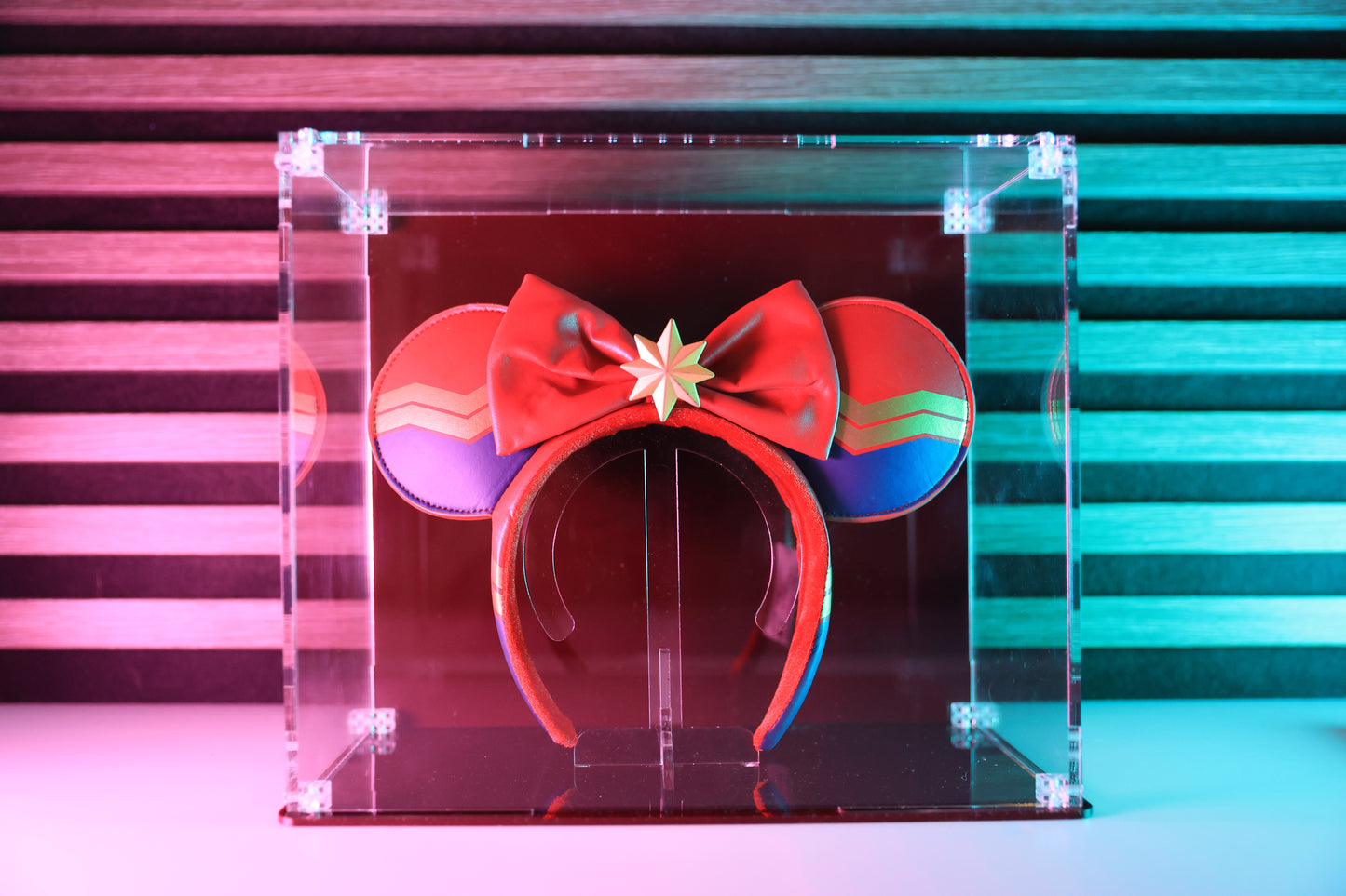 Mickey ears headband in a clear display case with coloured base and coloured back.